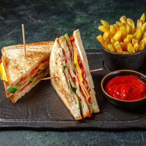 front-view-tasty-ham-sandwiches-with-french-fries-dark-surface